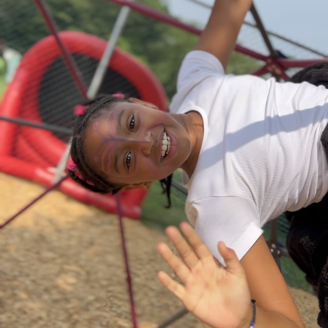 Girl with face paint on playground