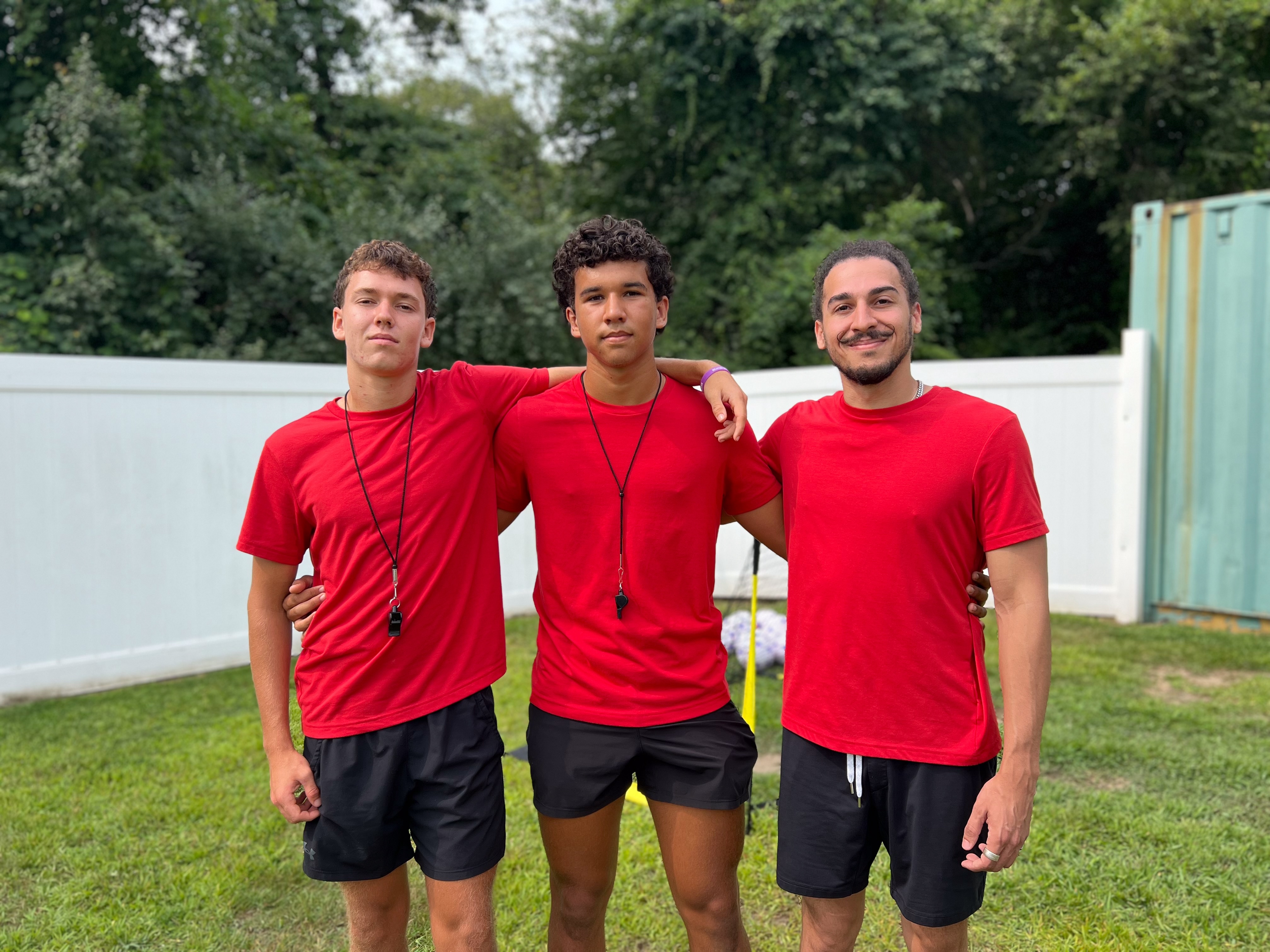 Camp counselors in red shirts
