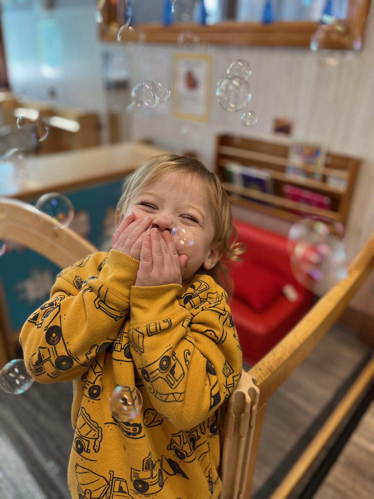 Toddler laughing with bubbles