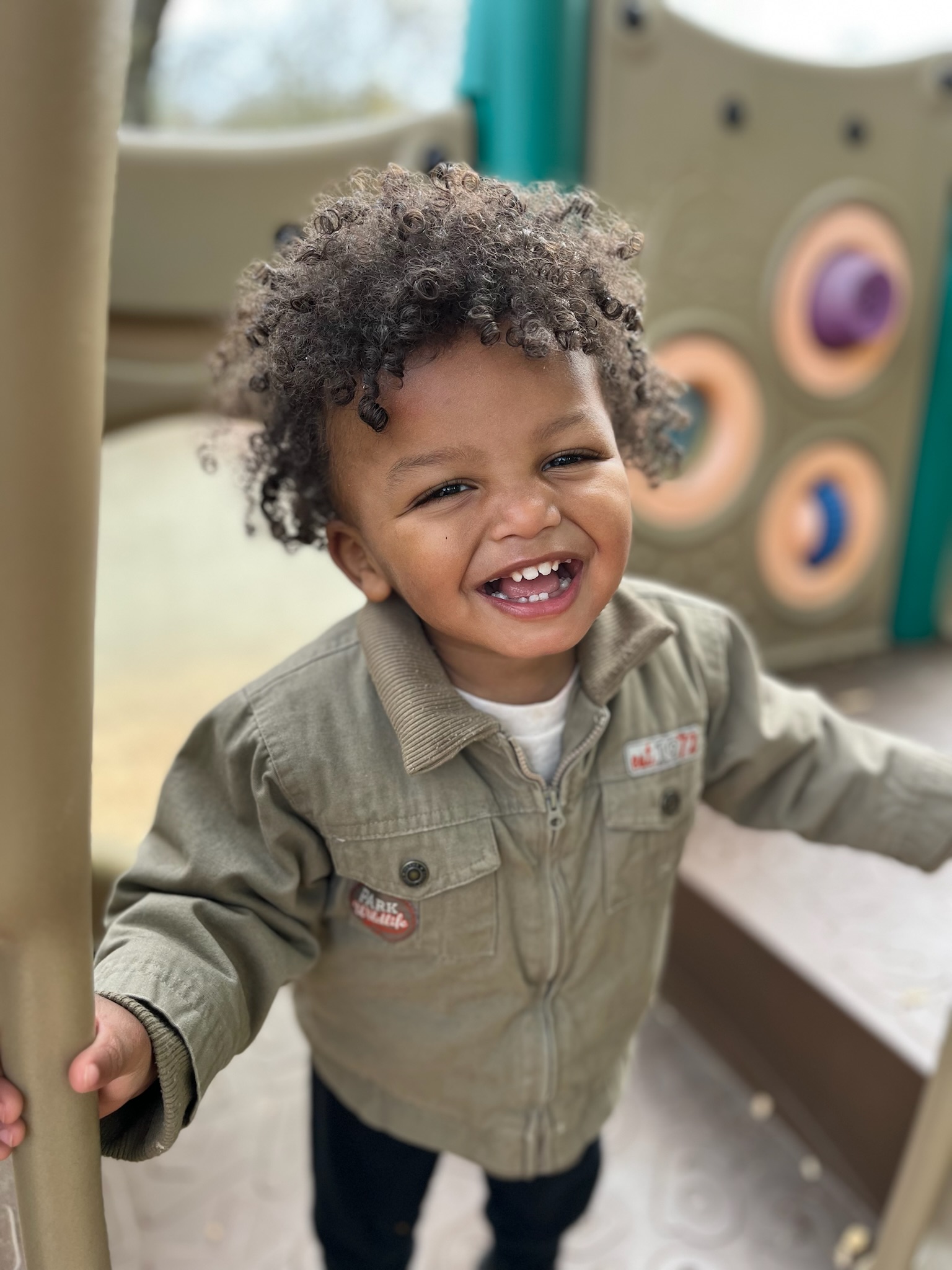 Toddler smiling on the playground